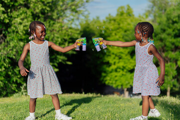 Two african american girls playing in the park