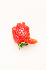 Unusual strawberry in the shape of hand with thumb up similar the like sign, beige background, top...