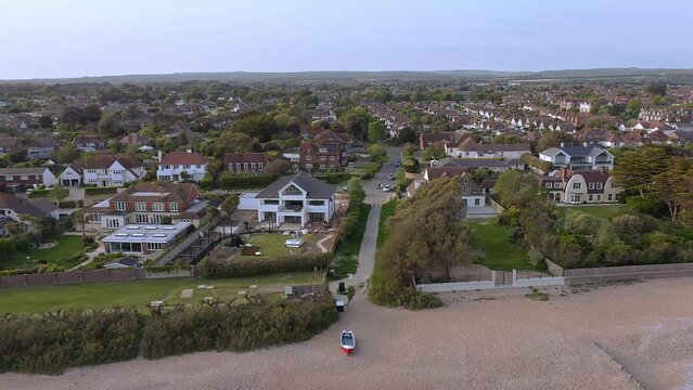 Aerial footage of sea lane from the sea with the beautiful village of East Preston and Willowhayne in West Sussex England in view.