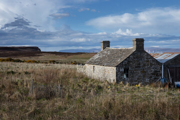 Abandoned house. Stone shed. Barn. Dunnet Head. Scotland. Brough. Orkney Islands in the back..