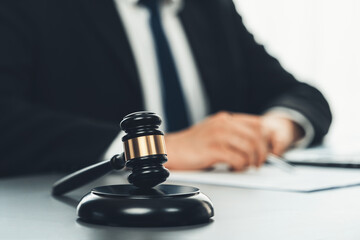 Focus gavel hammer for righteous and equality judgment with blur background of lawyer colleagues or...