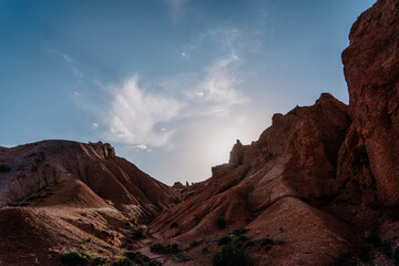 rocks in the desert in kirgystan with clouds and sunset