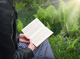 Girl reading a book in the park