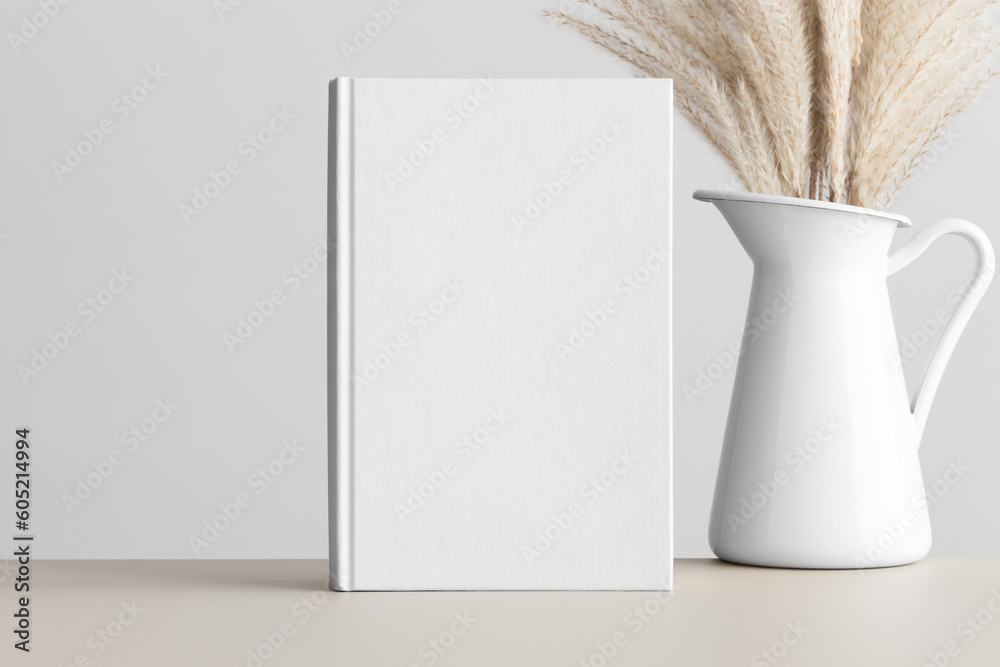 Canvas Prints White book mockup with a reed pampas decoration on the beige table.