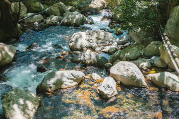 Female slackliner walking a highline over a waterfall