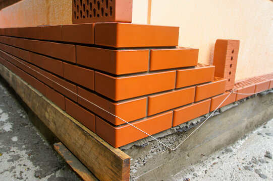 Reconstruction of country house. Insulation of brick facade of facade with help of penoplex. Facade decoration of walls with facing bricks close to thermal insulation layer.