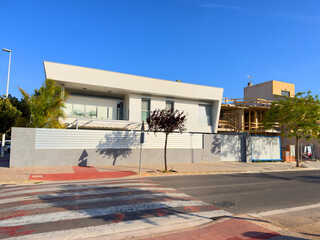 Villa at Spain seaside. Coast Home in residential area. Waterfront vacation home. Luxury villa under construction near beach of Mediterranean sea. Construction of modern house. Suburb house building.
