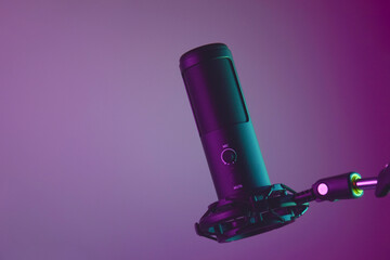 Studio condenser microphone isolated on dark background.