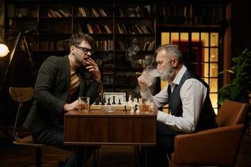 Family of intelligent people playing chess, smoking cigars and drinking whiskey