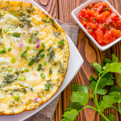 omelette, parsley and stewed tomatoes with fennel on the wooden background