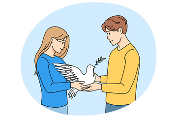 Fototapeta premium Man and woman holding dove in hands