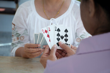 Retired people playing card in a retirement home.