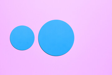Paper pink background with shaped blue elements.