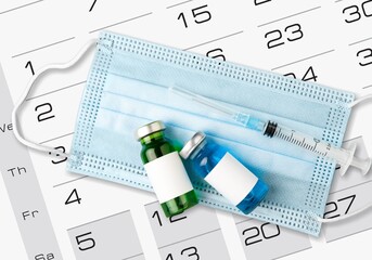 A medical syringe and glass vial