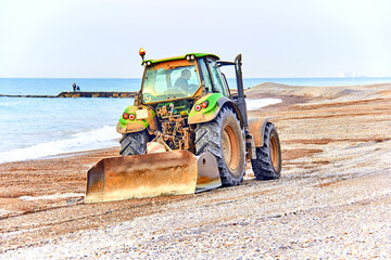 tractor combing the beach