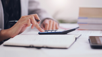 Fototapeta premium Calculator, accounting and hands of a woman writing in notebook for business budget, investment or planning. Accountant person with pen for tax list on profit, financial goals or income on a desk