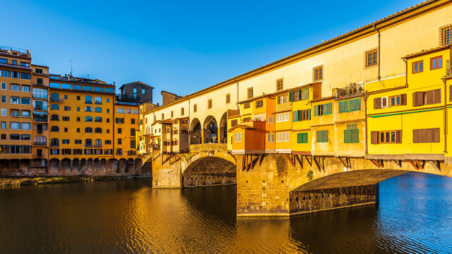 The bridge Ponte Vecchio enlighted by a strong morning sunlight in Florence.