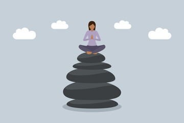 meditating woman sitting on a stack of zen stones work life balance concept