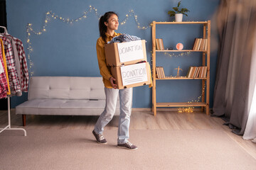 Young woman with donation boxes in her home office. Donation concept