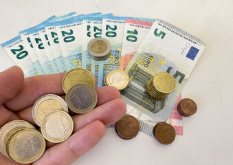 Euro coins on hand. Euro Money and cash background. Euro Money Banknotes for pay. Euro bills and coins in Crisis of the European Union. Coins and bills for pension.