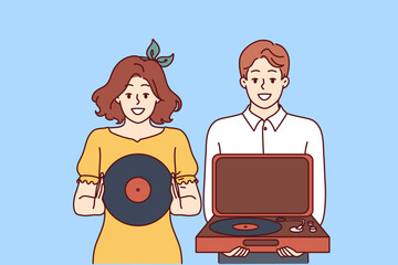 Happy couple with turntable and vinyl record invites you to retro party with jazz music. Young man and woman collecting vintage vinyl records with music from their favorite artists.