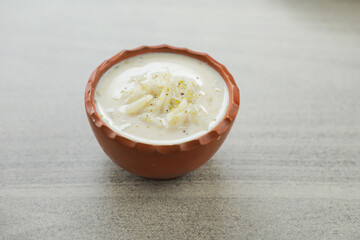 chui pitha, kheer, firni served in pot isolated on mat top view of indian, bangali and pakistani dessert mithai
