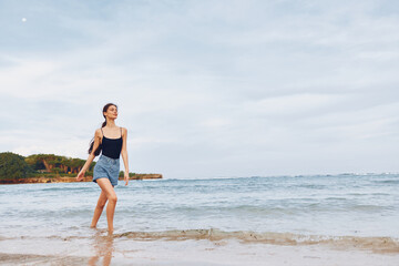 Fototapeta na wymiar woman summer beach running sea sunset lifestyle young travel freedom smile