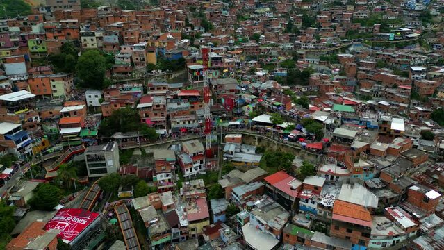 Comuna 13 Medellin Colombia escaleras electricas, graffiti and pablo escobar tour,  tourist attraction. 4k drone shot, view from above, cellphone tower