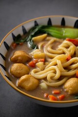 Bowl of steaming hot udon noodles cooked in a fragrant curry sauce