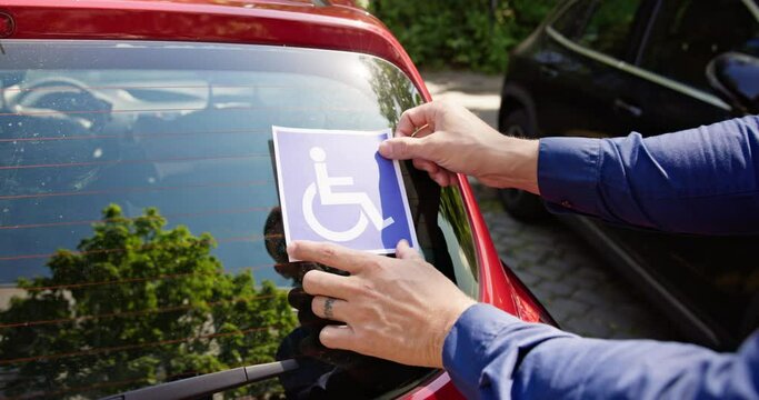 Driver Putting Wheelchair Sticker Sign