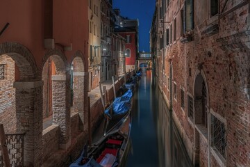 Picturesque scenery around the tranquil canals at night in Venice, Italy