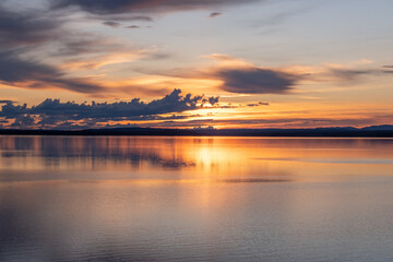Fototapeta na wymiar Golden sunset on Lake Gåxsjön, Hammerdal, Sweden. 