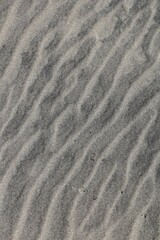 Fototapeta na wymiar Top view of wavy lines on the sand on the beach