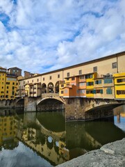 Fototapeta na wymiar Vertical shot of the Ponte Vecchio medieval arched bridge with buildings