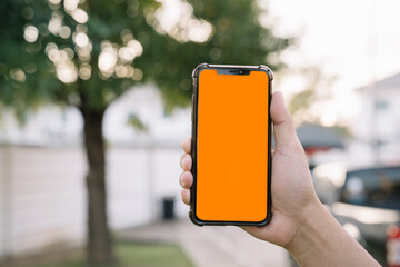 Man holding smartphone, close-up of hands. Space for text.