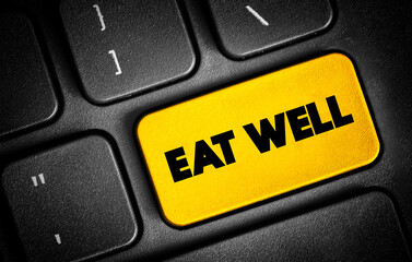 Eat Well text quote on keyboard, concept background