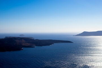 Aerial view of a blue ocean in summer with a blue sky in the background in Oia, Santorini