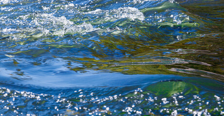 flow of water and spray from a stone