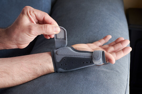 Hand with tendinitis in the wrist with a thumb abduction wrist brace.