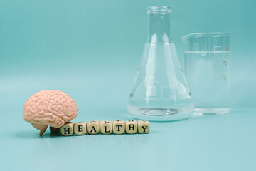 Brain on a blue background. lettering health. Place for text. White pills for memory. Chemical flasks. Drug laboratory.