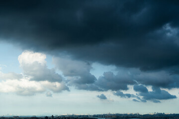 Fototapeta na wymiar Dark clouds over the city buildings