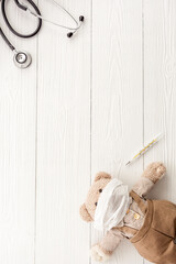 Obraz na płótnie Canvas Kids medical checkup and health concept with stethoscope and teddy bear