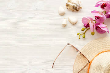 Beach accessoties with sunscreen cosmetic and straw hat. Summer beach concept flatlay