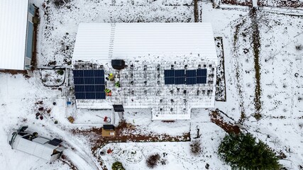Contractors installing solar panels on a house roof winter 01
