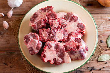 Raw beef Oxtail cut Meat on cutting board. Top view.