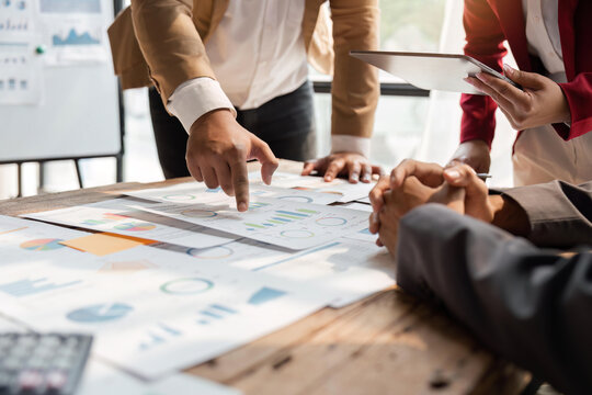 Business team analyzing income charts and graphs with calculator and tablet. Close up. Business analysis and strategy concept