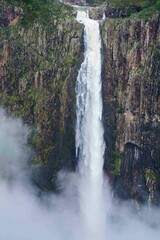 Majestic waterfall cascading into a tranquil pool of water, Wallaman Falls, Australia
