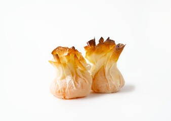 Traditional Portuguese sweets with egg cream - tulhinhas on white background