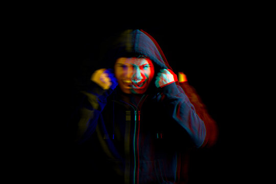 Paranoia. Man screaming on black background, glitch effect