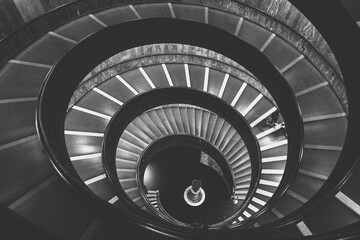 Greyscale shot of a spiral stairs